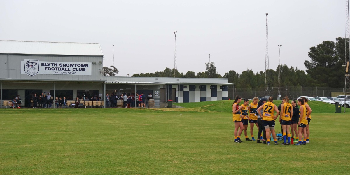 Exterior of Football Club Building Facing Sports Field with Sport Team
