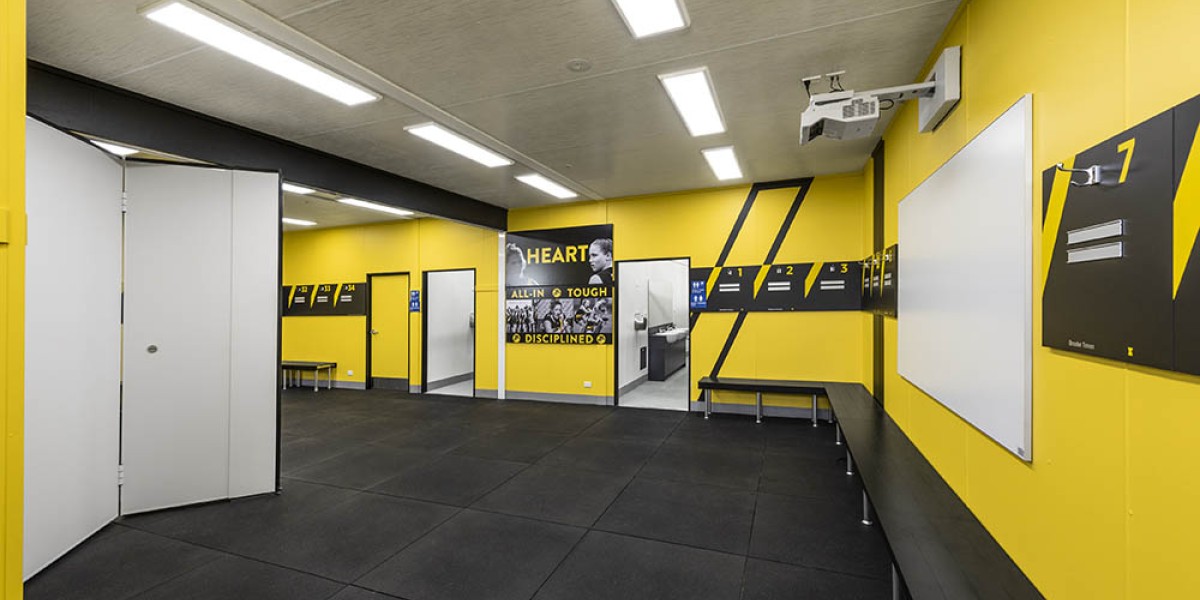 Interior Sports Change Room with Yellow Walls, Bifold Door and Bench Seating