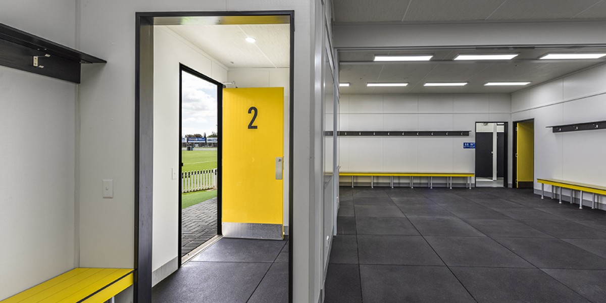 Interior Sports Change Room with White Walls, View of Entrance and Yellow Bench Seating