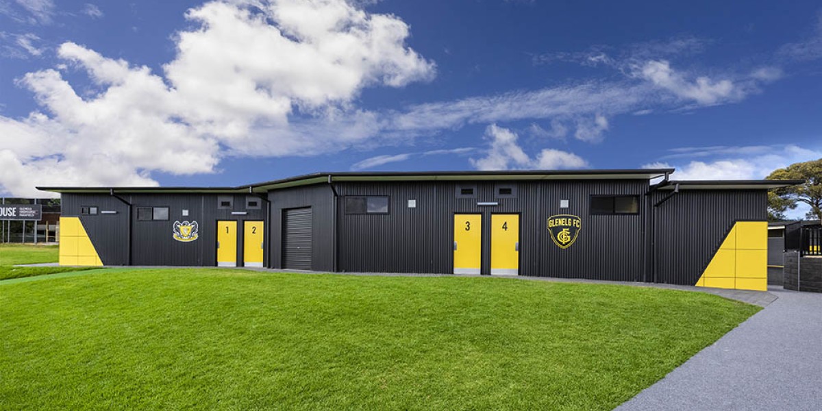Exterior Sports Building with Corrugated Steel Cladding and Yellow Panelling and Doors