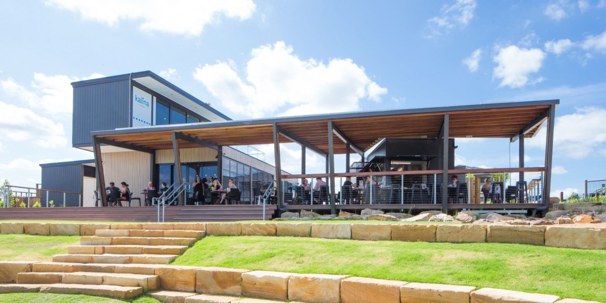 Outdoor Undercover Deck with People Seated Facing Lawn with Stone Stairs and Retaining Walls