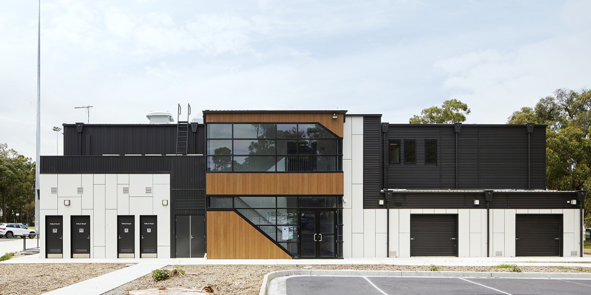 Modular Building with Black and White Panelling and Windows Facing Parking Lot