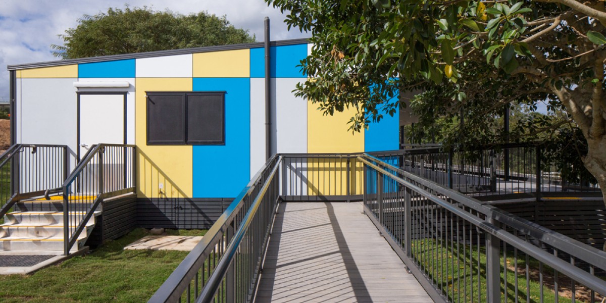 Multi-Coloured Modular Building with Cement Ramp and Grey Railings
