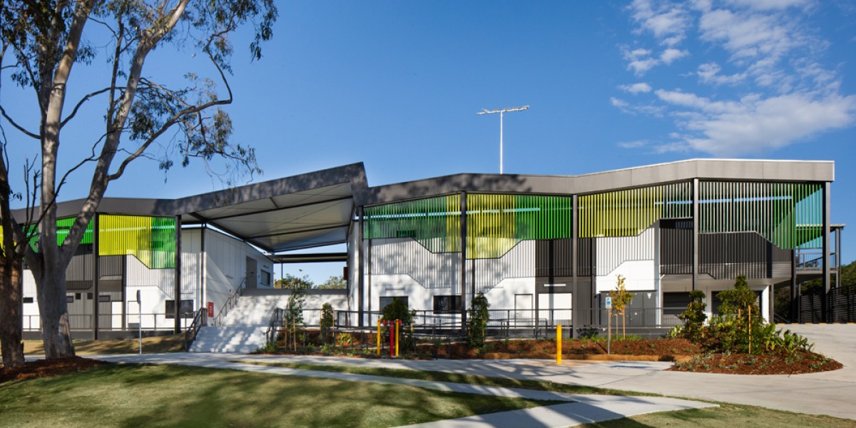 Modular Building on Lawn, with Grey Awnings and Green Facade