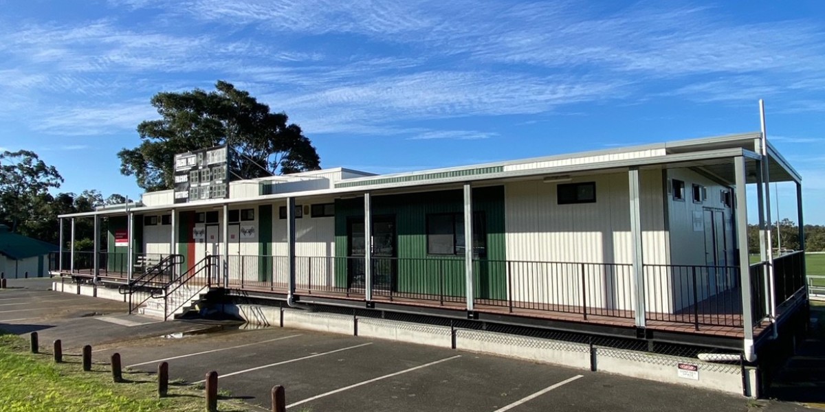 Exterior of Sports Facility Building in Bitumen and Lawn