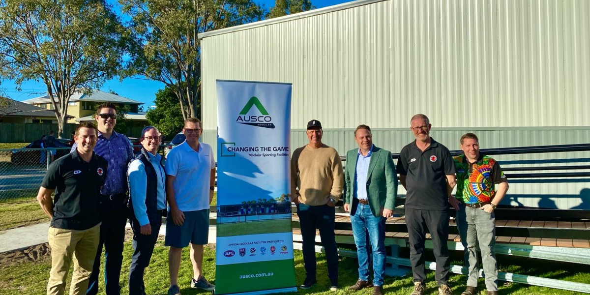 Eight Men Standing with Ausco Modular Sign Outside