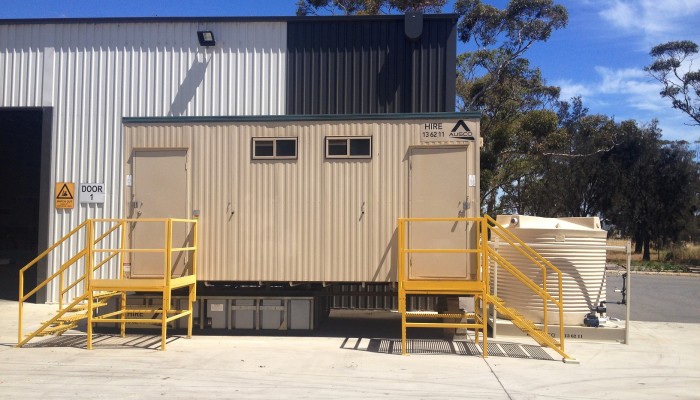 Water tanks supporting an Ausco toilet building