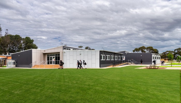 Exterior Modular School Building with White and Grey Panelling in Front of Lawn