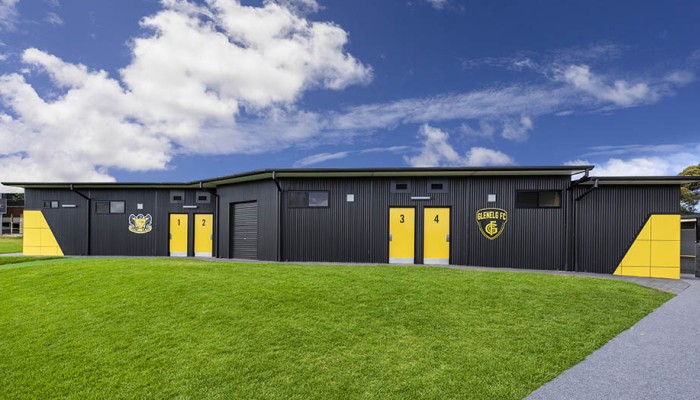 Exterior Sports Building with Corrugated Steel Cladding and Yellow Panelling and Doors