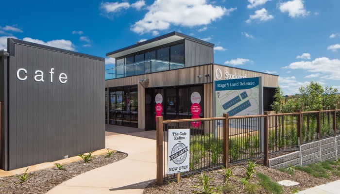 Exterior Modular Sales Office with Wooden Panelling and Stockland Signage