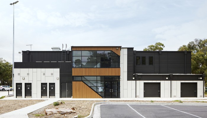 Modular Building with Black and White Panelling and Windows Facing Parking Lot