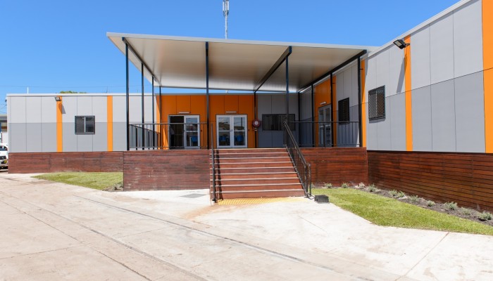 Exterior Modular Building with Grey and Orange Panelling, Covered Deck and Stairs