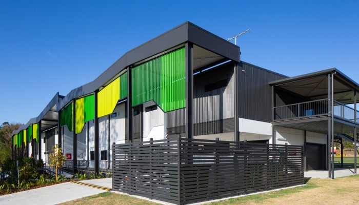 Modular Building with Green Facade, Grey Awnings and Fencing