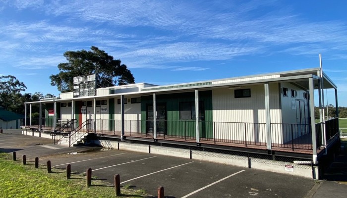 Exterior of Sports Facility Building in Bitumen and Lawn