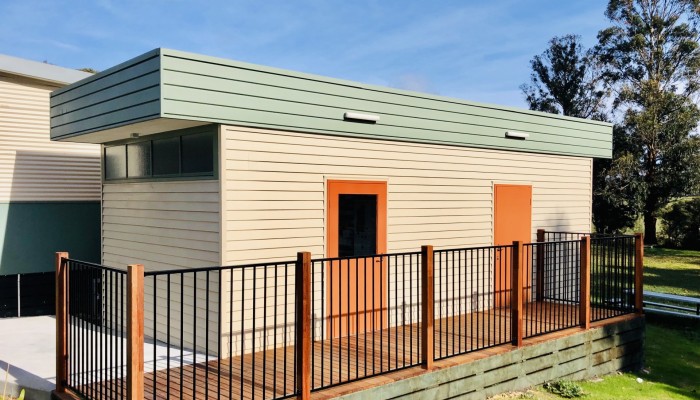 Modular Building with Wooden Panelling and Fenced Deck Walkway