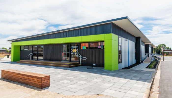Exterior School Building with Tiled Pavers and Lime Green Panelling