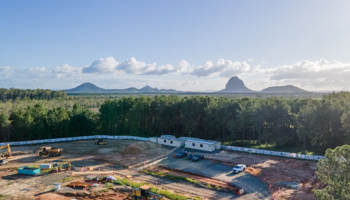 An aerial photo of the Deluca site, with the glasshouse mountains in the background.