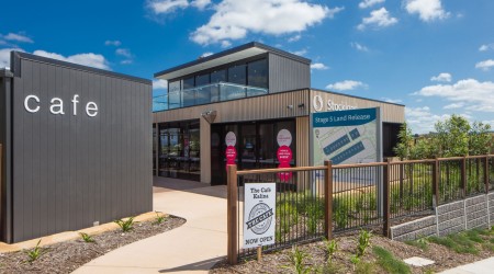 Exterior Modular Sales Office with Wooden Panelling and Stockland Signage