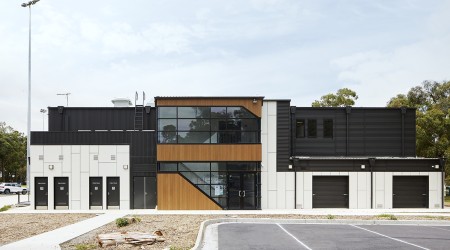 Modular Building with Black and White Panelling and Windows Facing Parking Lot