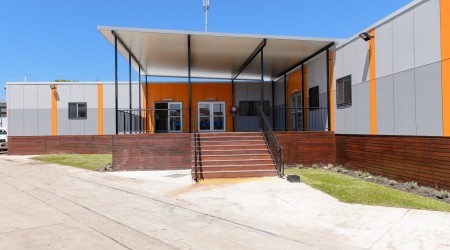 Exterior Modular Building with Grey and Orange Panelling, Covered Deck and Stairs
