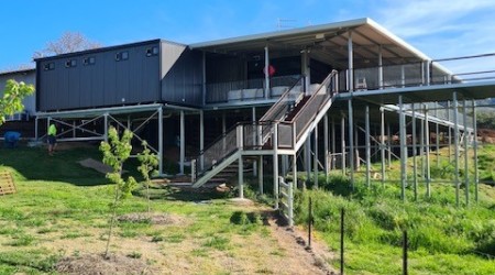 Exterior Modular Building on Grassy Field with Stairway