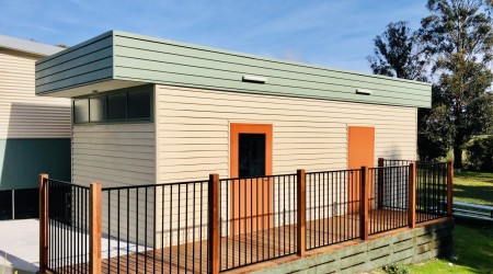 Modular Building with Wooden Panelling and Fenced Deck Walkway