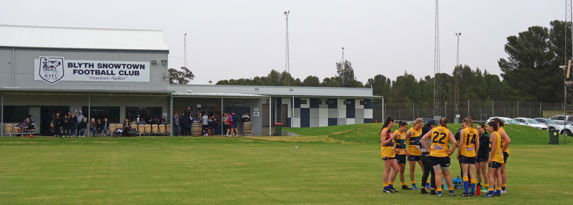 Exterior of Football Club Building Facing Sports Field with Sport Team