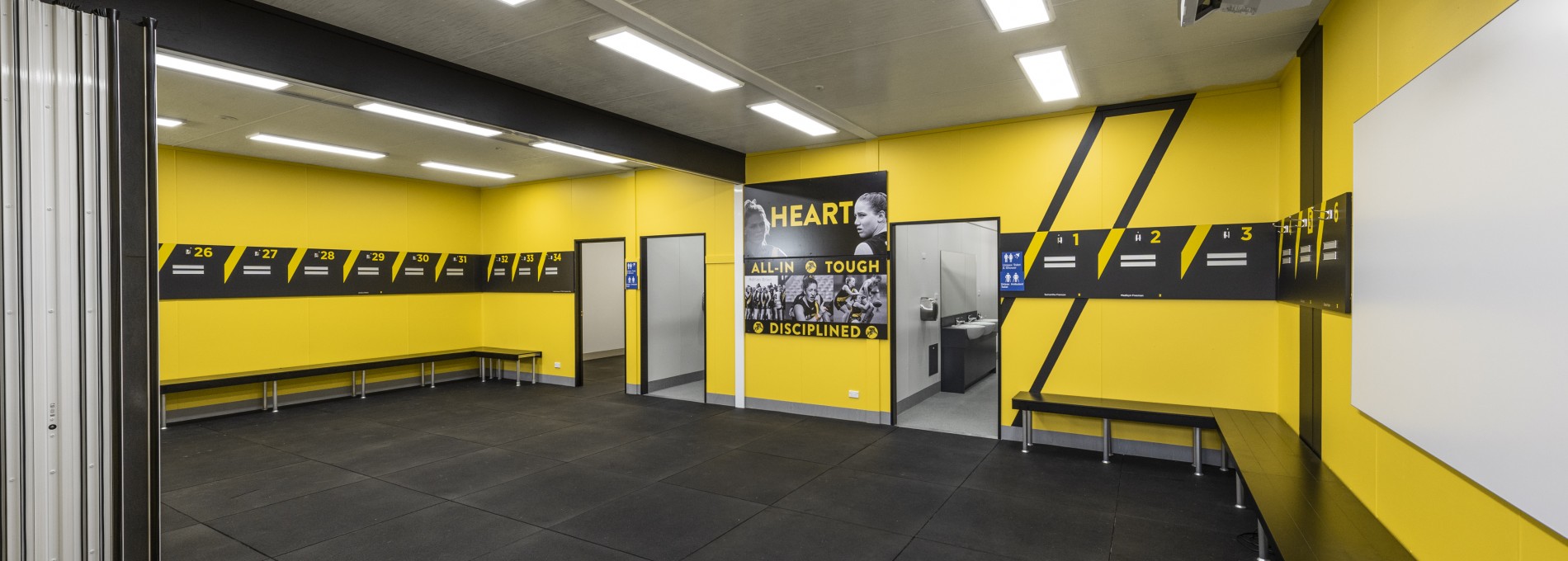 Yellow Sports Change Room with Bifold Doors and Benches