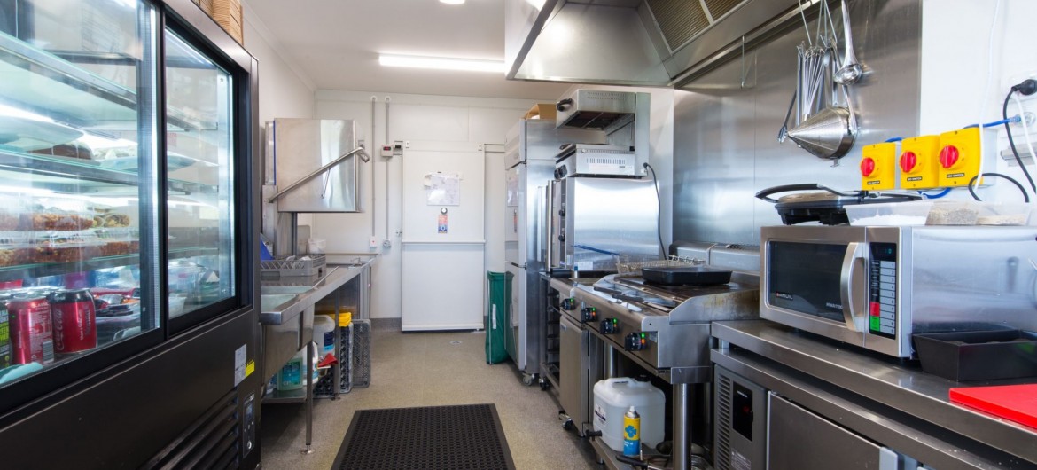 Interior Commercial Kitchen with Appliances and Fridges
