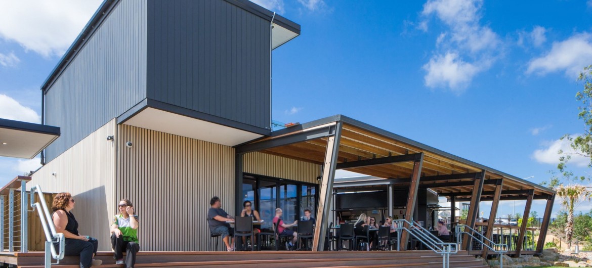 Exterior Sales Office with Outdoor Undercover Deck with People Seated and Stairway