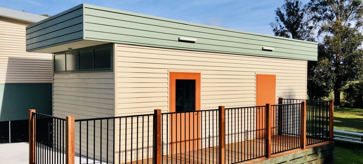 Modular Building with Wooden Panelling and Fenced Deck Walkway