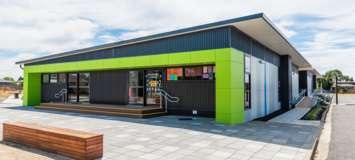 Exterior School Building with Tiled Pavers and Lime Green Panelling
