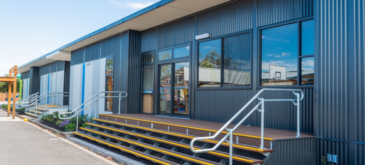 Exterior School Building with Corrugated Steel Cladding and Stairway