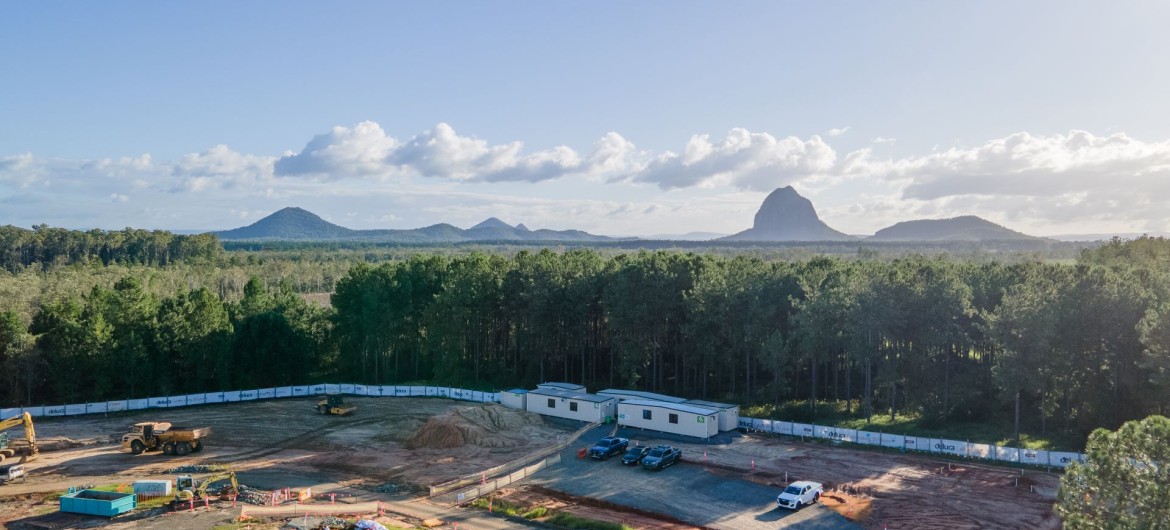 An aerial photo of the Deluca site, with the glasshouse mountains in the background.